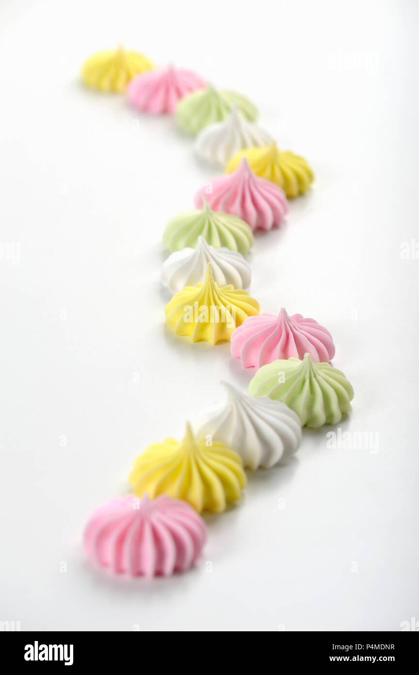 Colourful meringues on a white surface Stock Photo