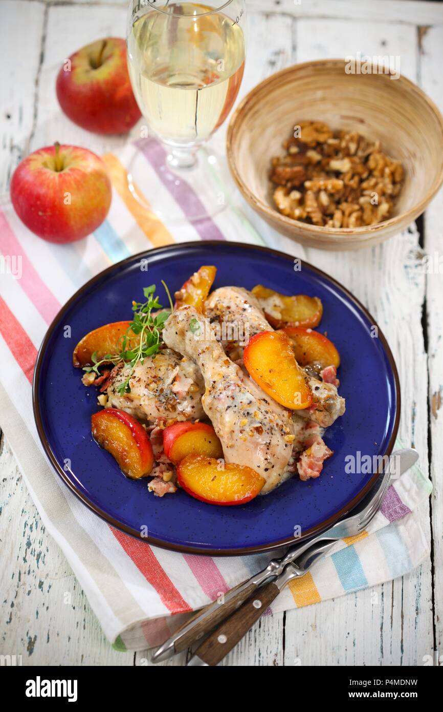 Chicken legs in cider with apples and walnuts Stock Photo Alamy