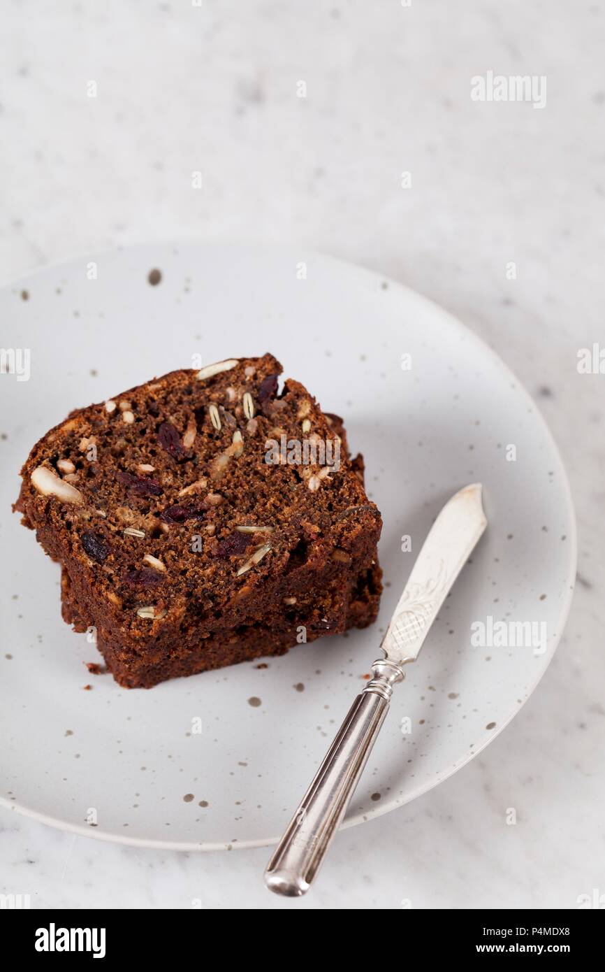 Two slices of banana bread with sunflower seeds, pumpkin seeds, cranberries, apple butter and walnut flour Stock Photo