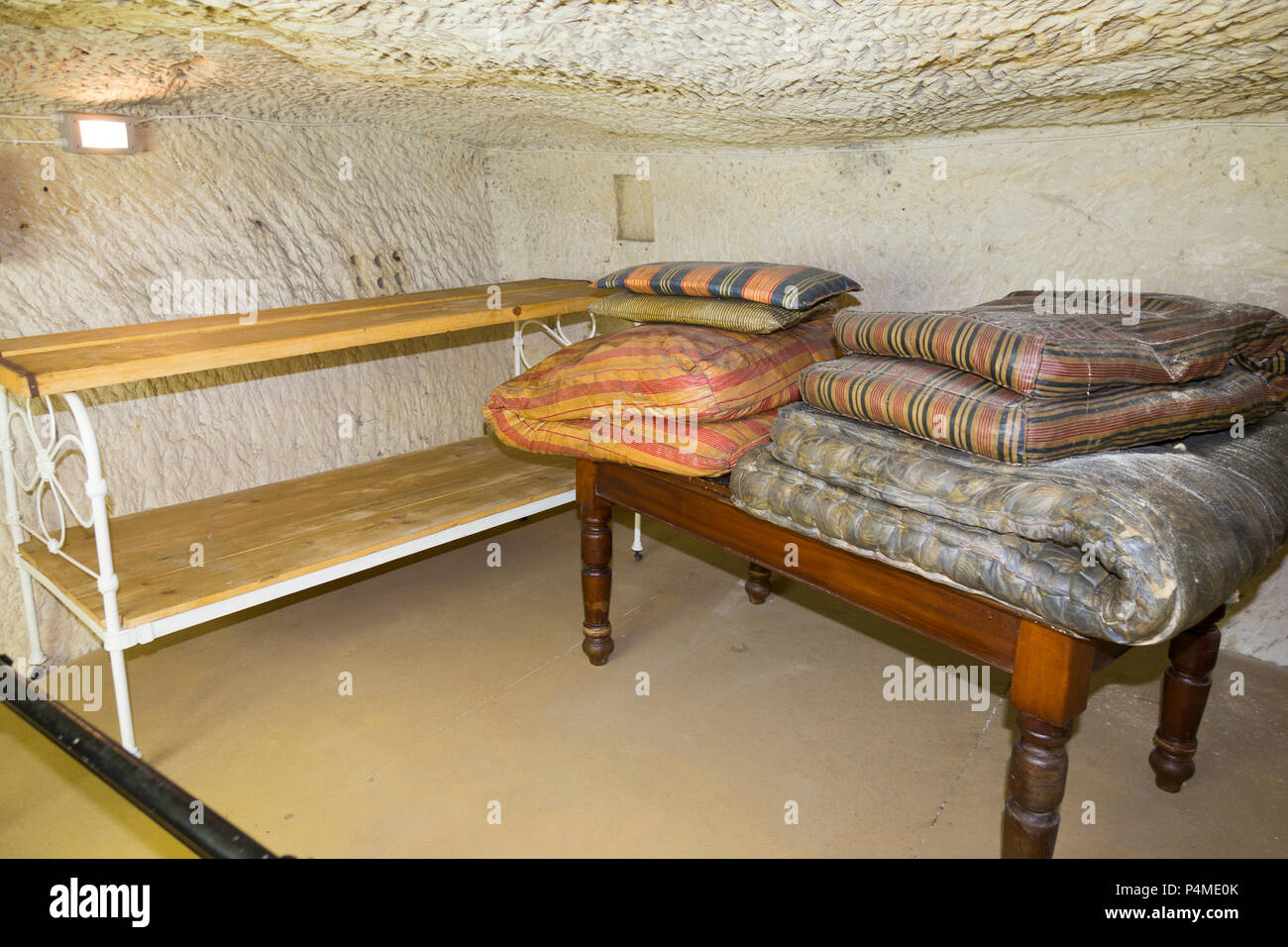 Room with tables demonstrating table shelter protection from air raid / shelter tunnel / tunnels inside / underground at the Malta At War Museum, Malta. (91) Stock Photo