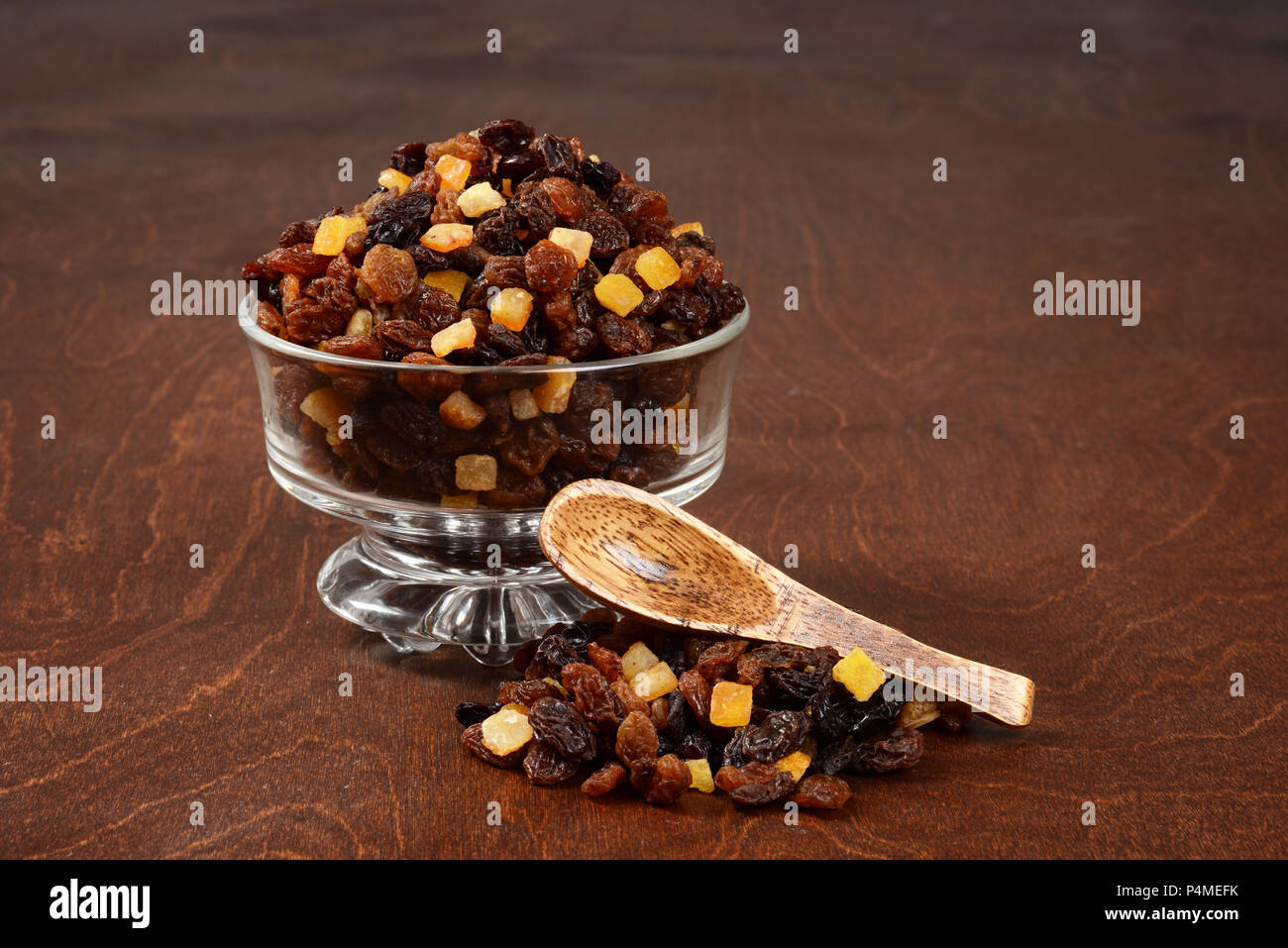 raisins currants and sultanas with mixed candied peel in a glass bowl with wood spoon Stock Photo