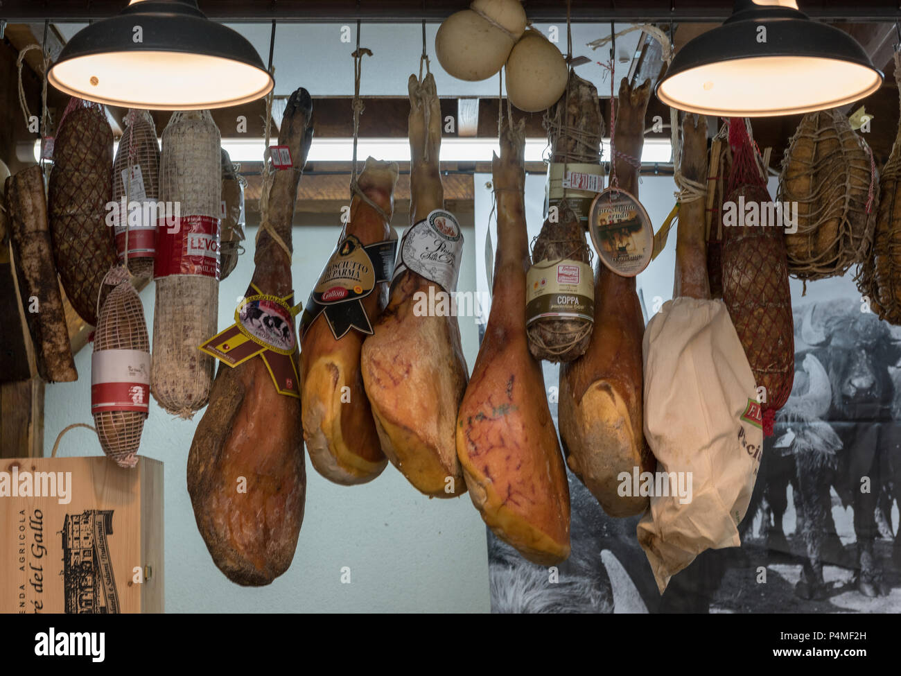 prosciutto ham hanging on a market stall Stock Photo Alamy