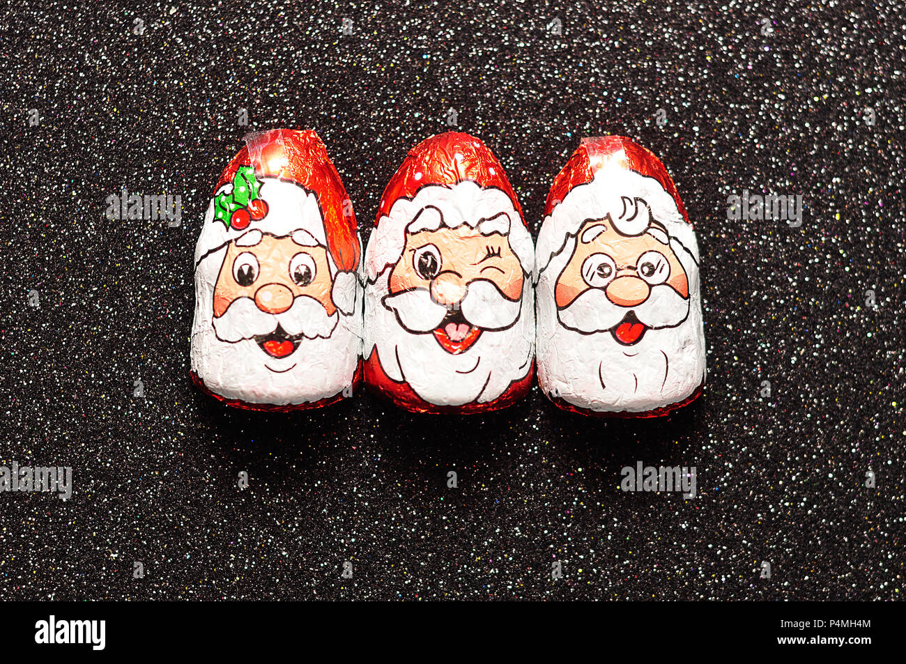 A row of chocolate covered with Santa Clauses face wrappers Stock Photo