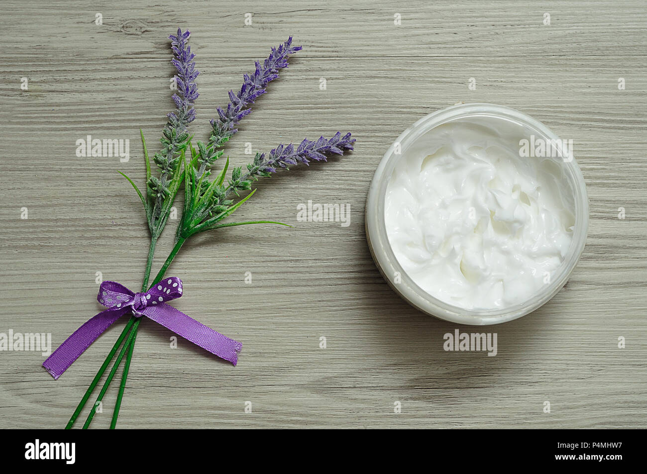 A bunch of lavender displayed with a container white body lotionbeauty, herb, green, relaxation, lavender, leaf, flower, bouquet, purple, ingredient,  Stock Photo