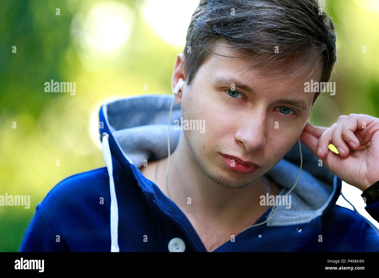 Belarus, Gomel, September 15, 2016. Central Park, a city holiday. Portrait of a young man with headphones Stock Photo