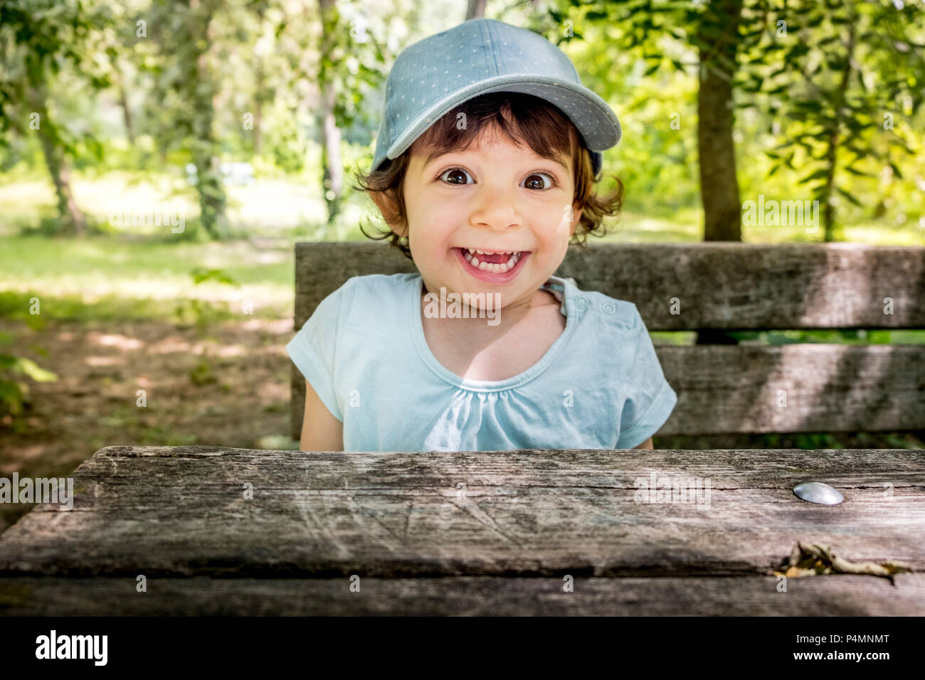 surprised children smiling joyful  - baby baseball cap - outdoor active naughty happy child . Stock Photo