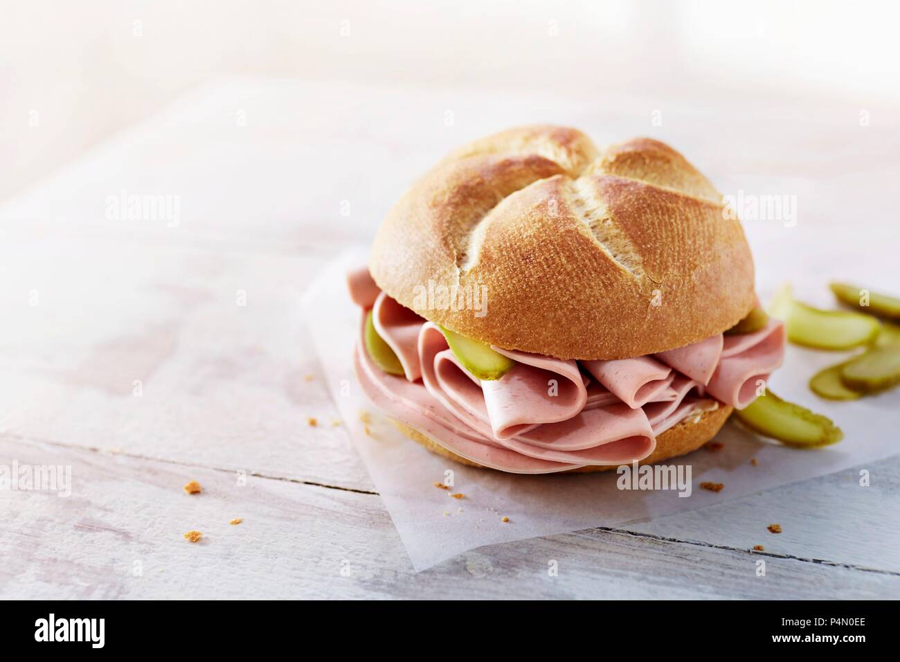 A roll with bologna and gherkins Stock Photo