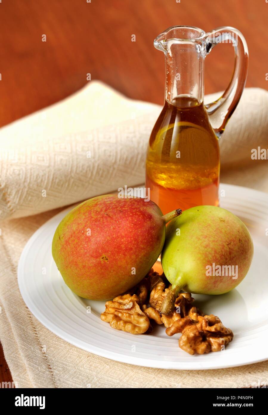 An arrangement of pears, nuts and liqueur Stock Photo