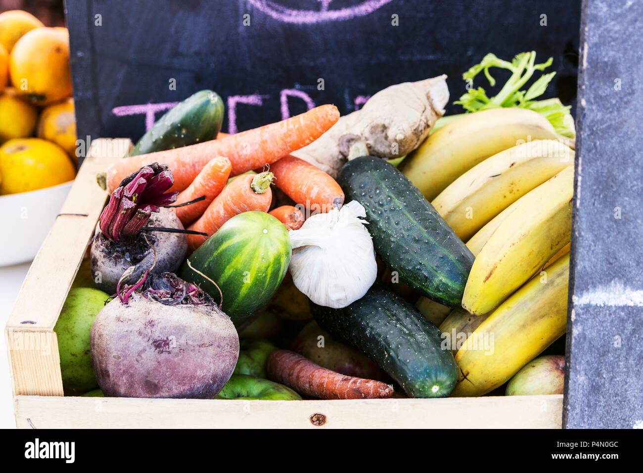 A wooden basket of different vegetables and fruits Stock Photo