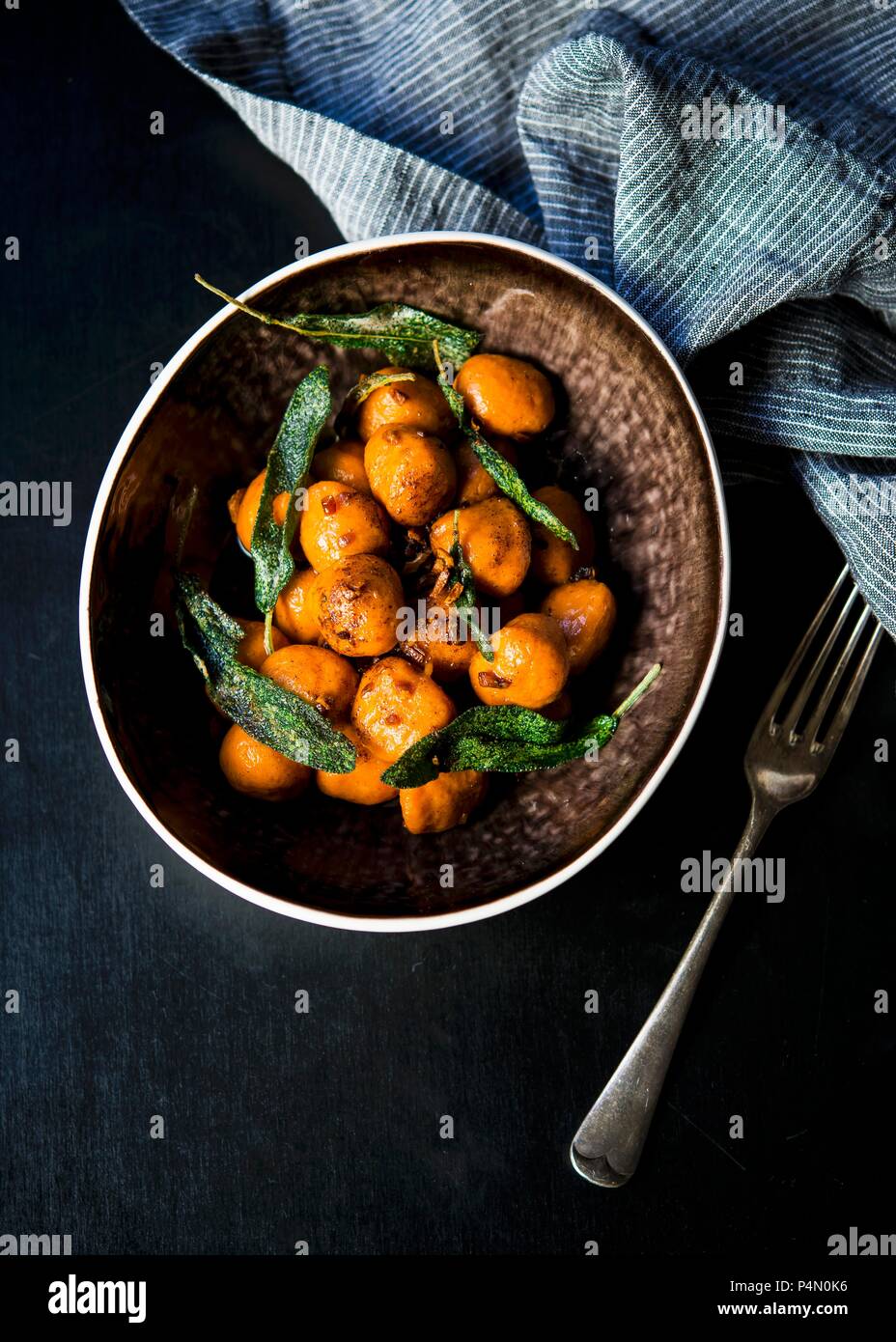 Homemade sweet potato gnocchi tossed in a sage and garlic butter Stock Photo
