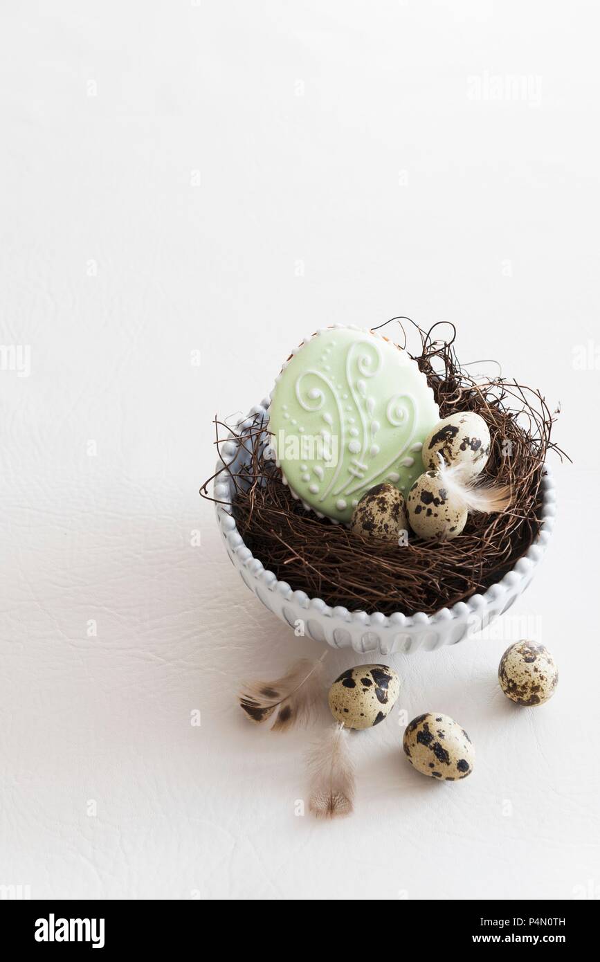 Easter biscuits and quail's eggs in an Easter nest Stock Photo