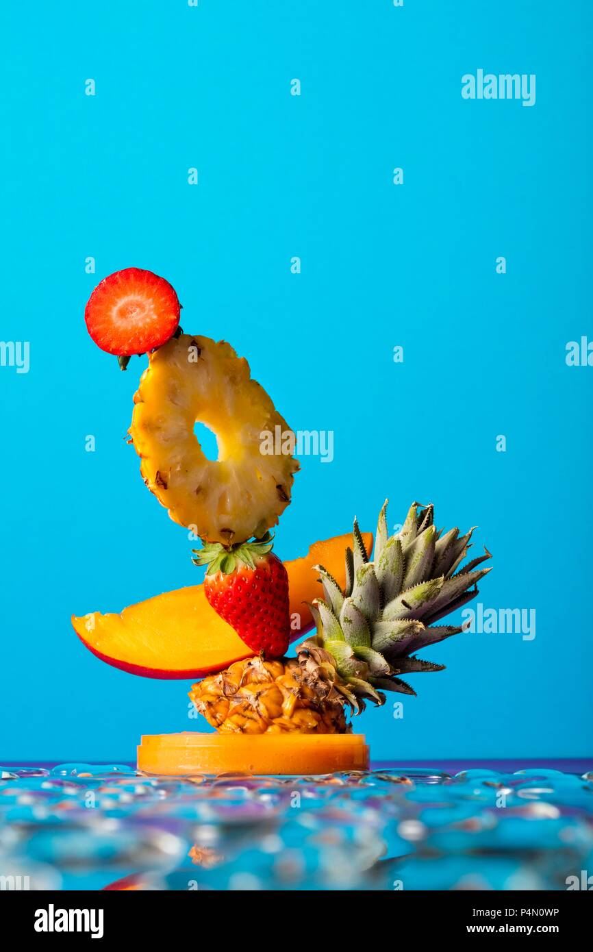 A fruit sculpture against a blue background Stock Photo