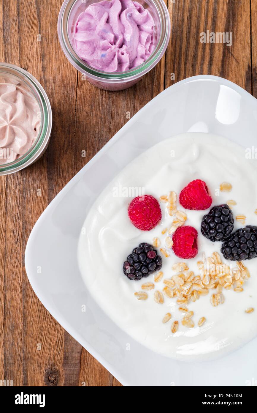 Yoghurt with oatmeal and fresh berries Stock Photo