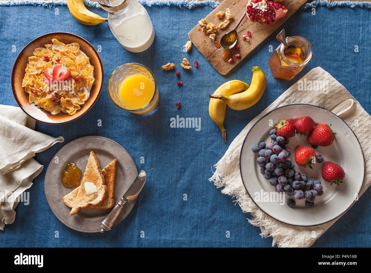 Assorted Breakfast Setting; Cold Cereal, Fruit, Toast and Orange Juice