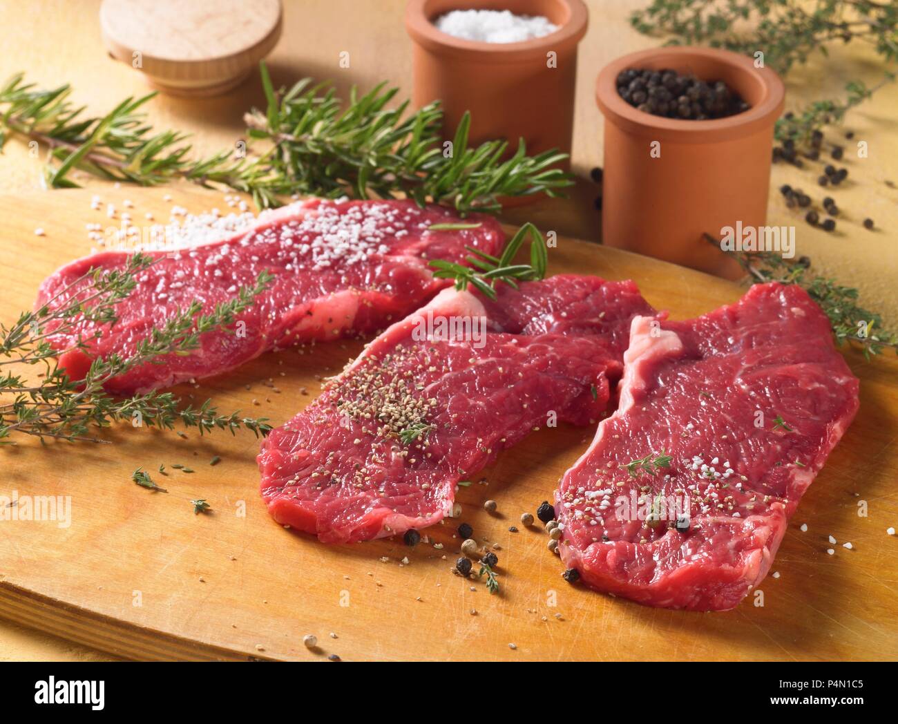 Spiced beef steaks with herbs and spices, ready to fry Stock Photo Alamy