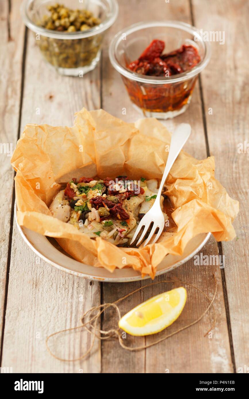 Baked cod with sundried tomatoes and capers Stock Photo Alamy