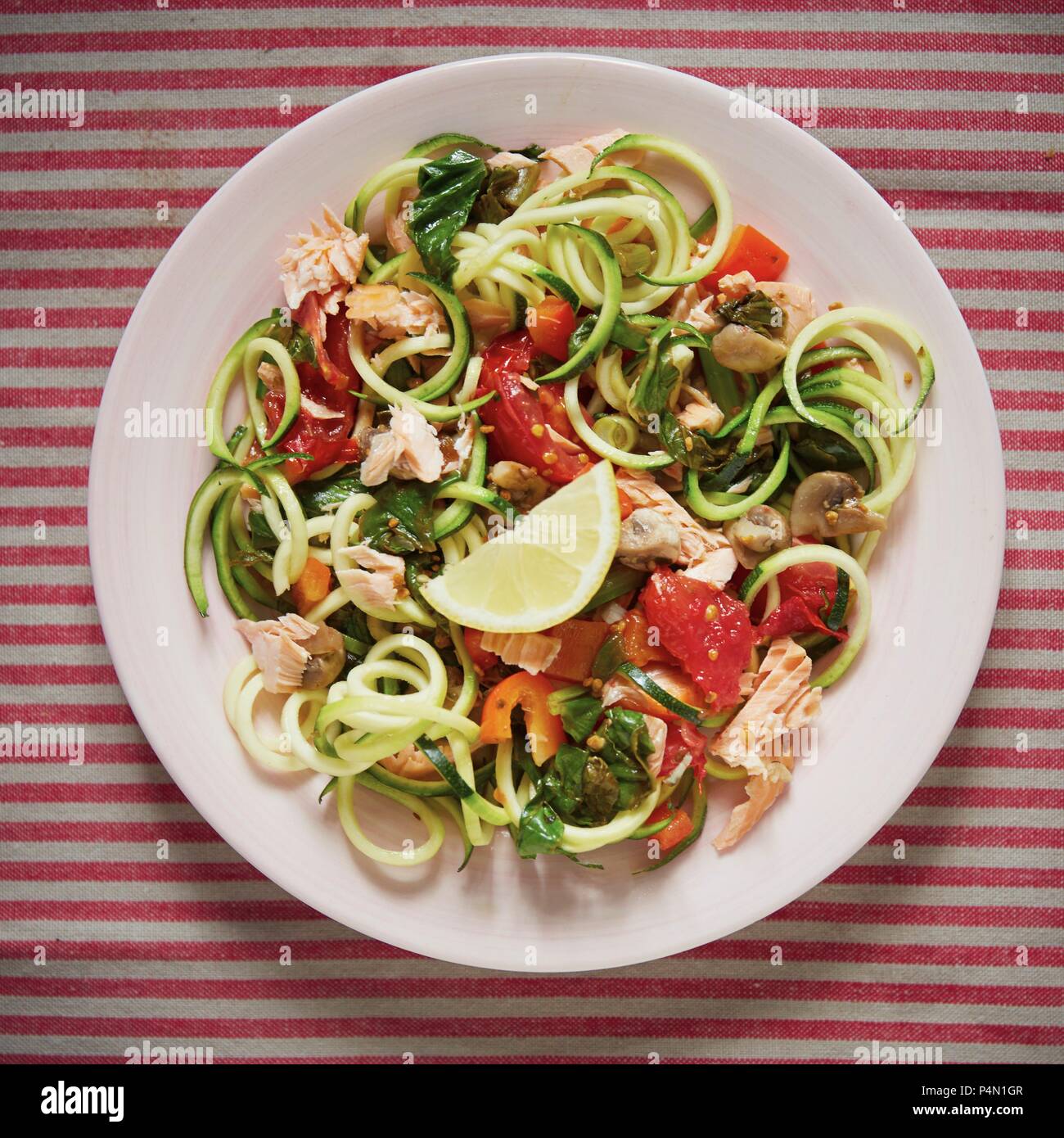 Courgette pasta with salmon Stock Photo