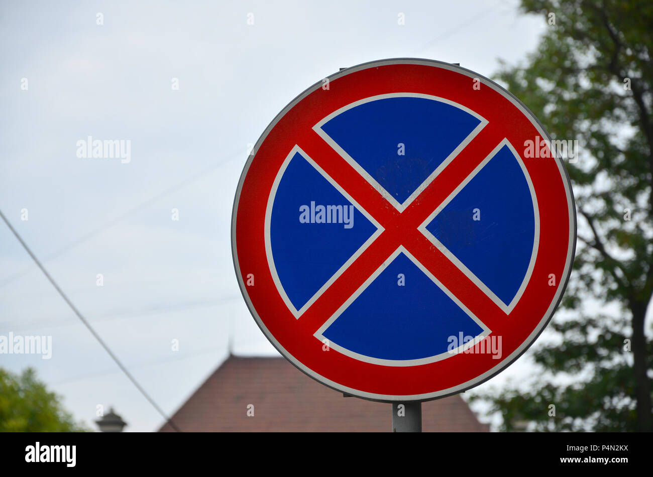 Round road sign with a red cross on a blue background. A sign means a parking prohibition . Stock Photo