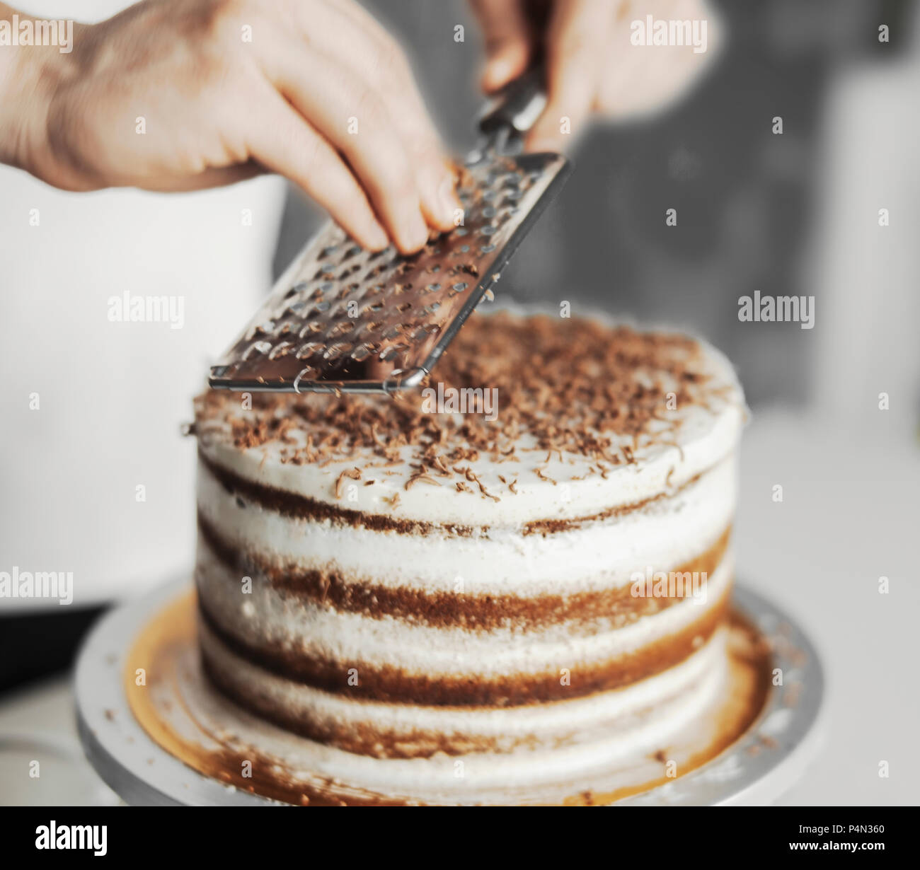 Young Attractive Man Decorating Cake With Dark Chocolate Stock