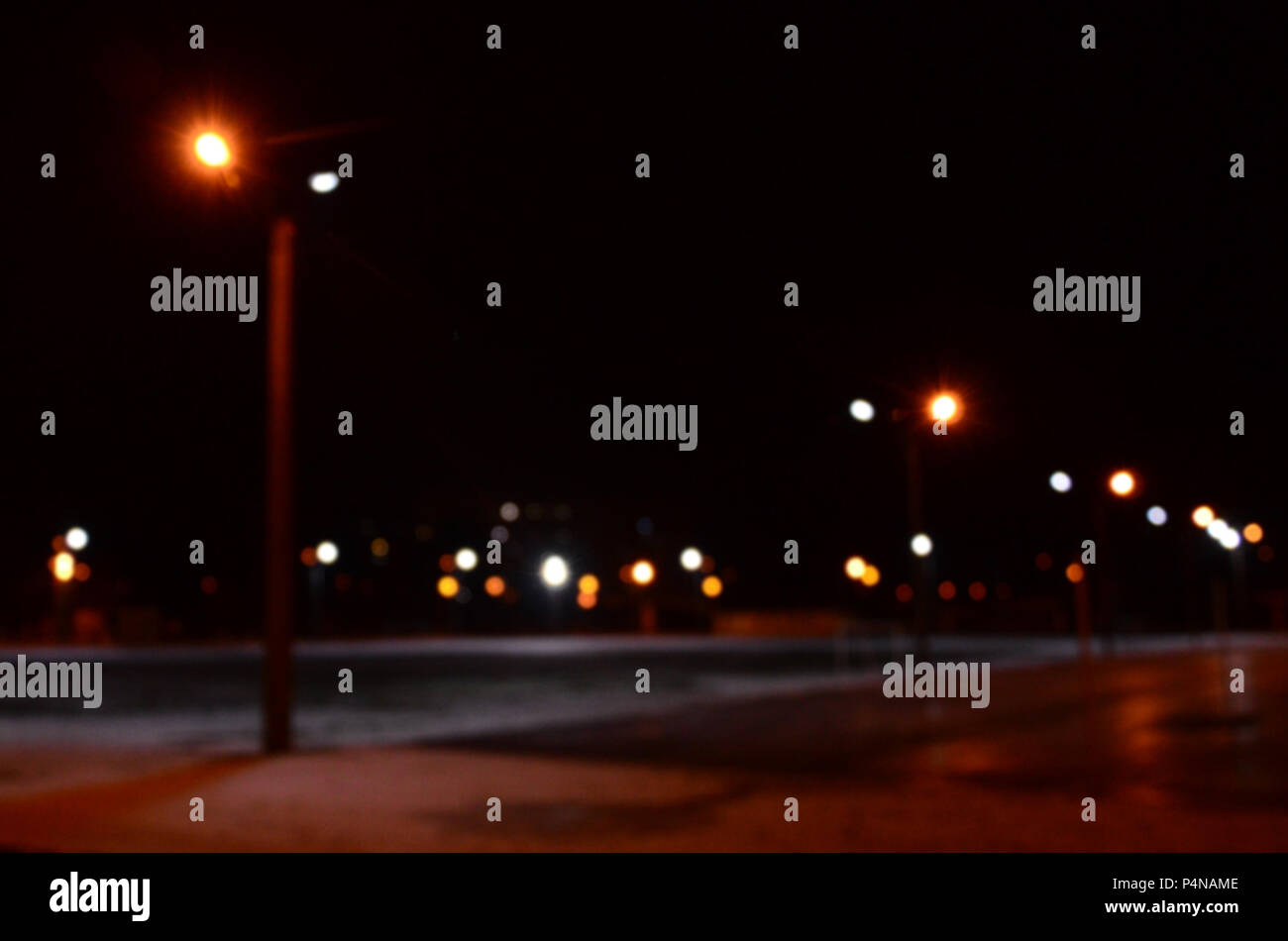 Blurred photo of school playground at night with bright lights Stock