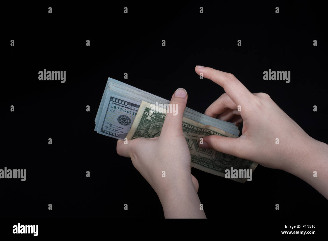 Hand holding American dollar banknotes isolated on white background ...