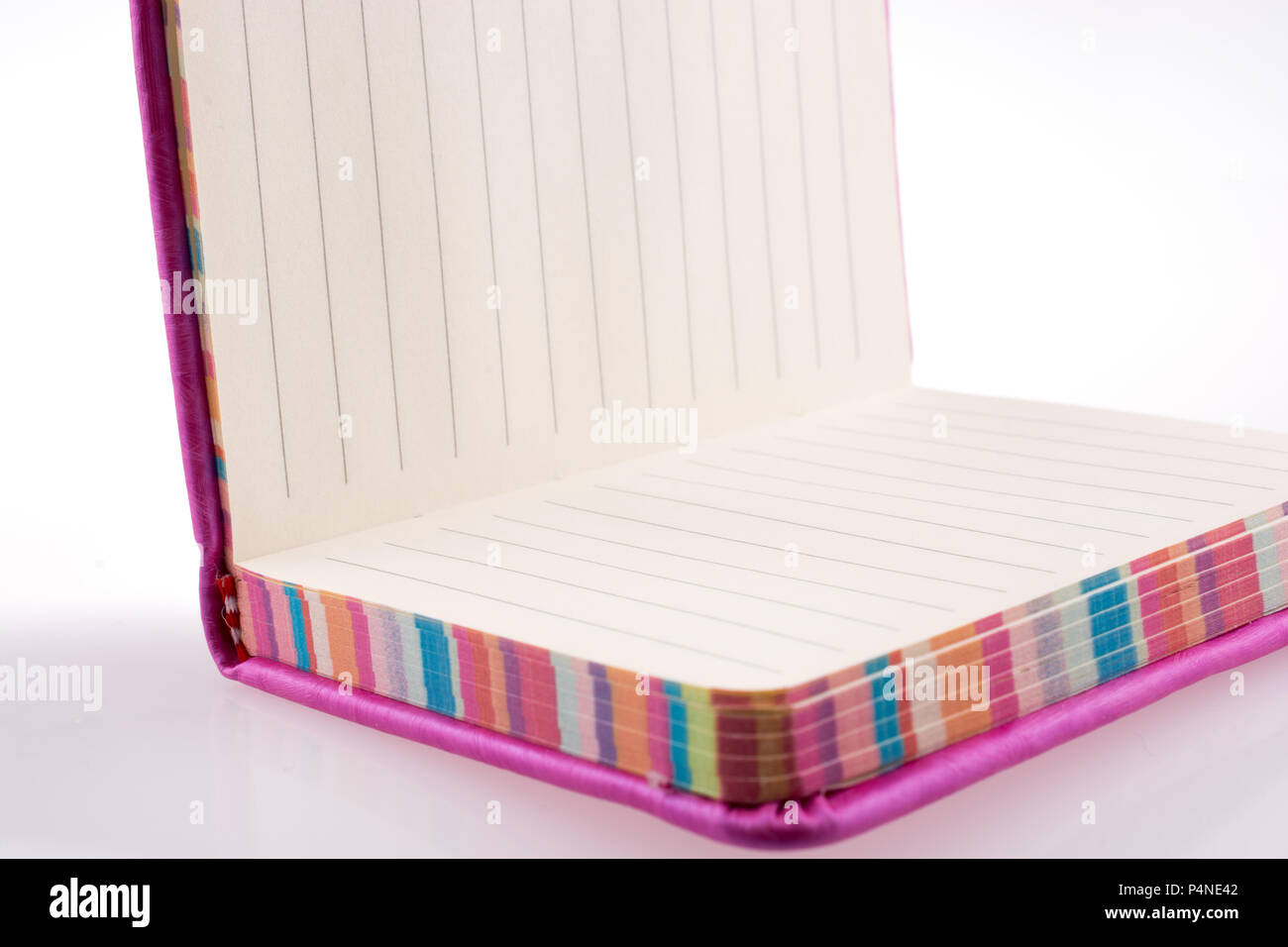 Pink notebook on a white background Stock Photo - Alamy