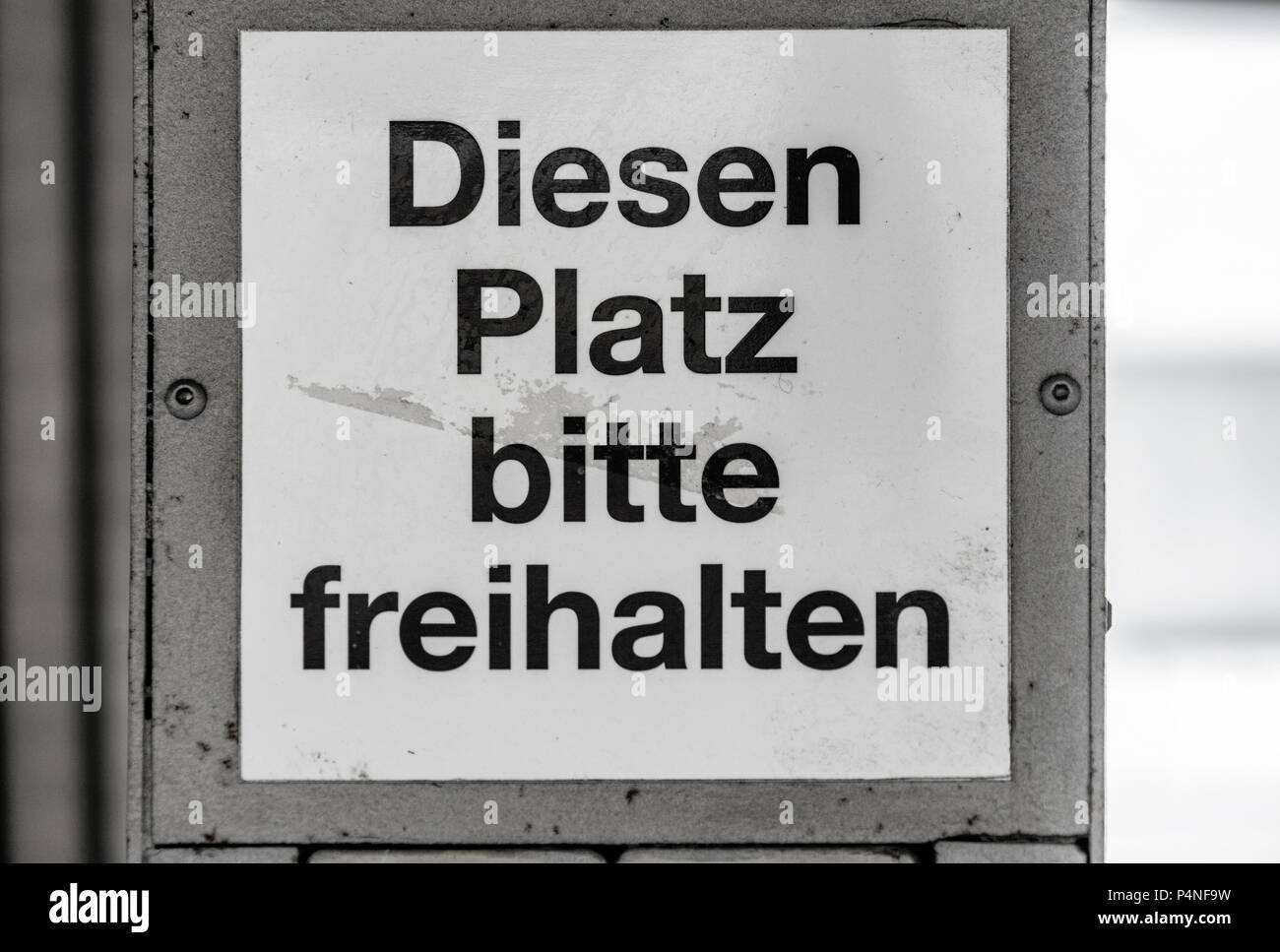 Dirty and ugly sign at a station with the German inscription 'Keep this place clear', Germany Stock Photo