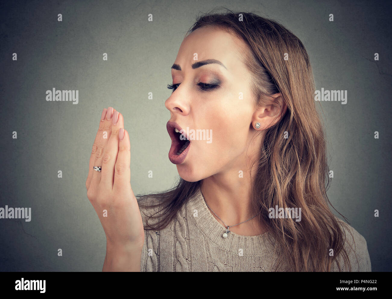 Woman doing a hand breath test. Stock Photo