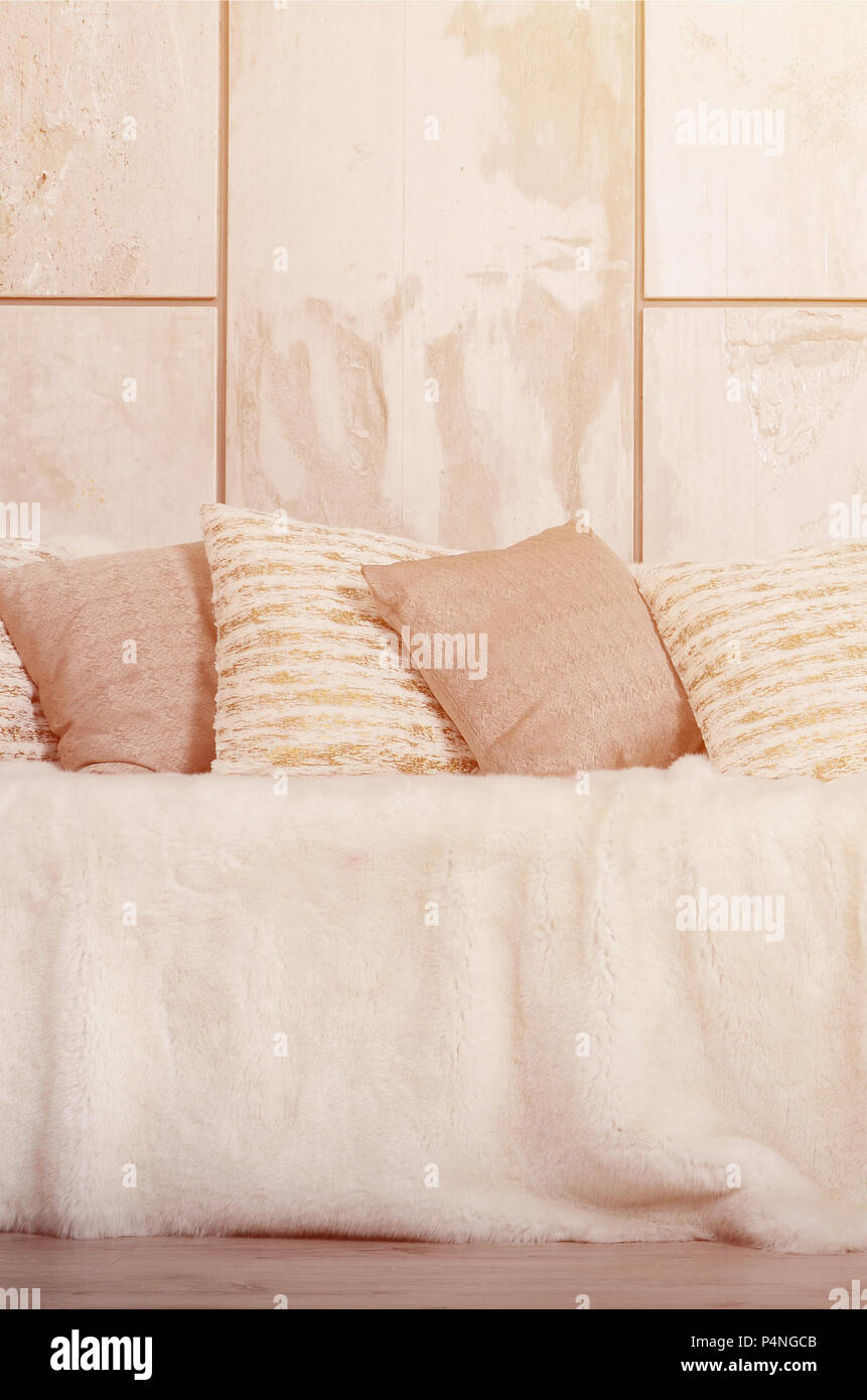 Many Pillows Lie On The Couch Which Is Covered With A Large Plush