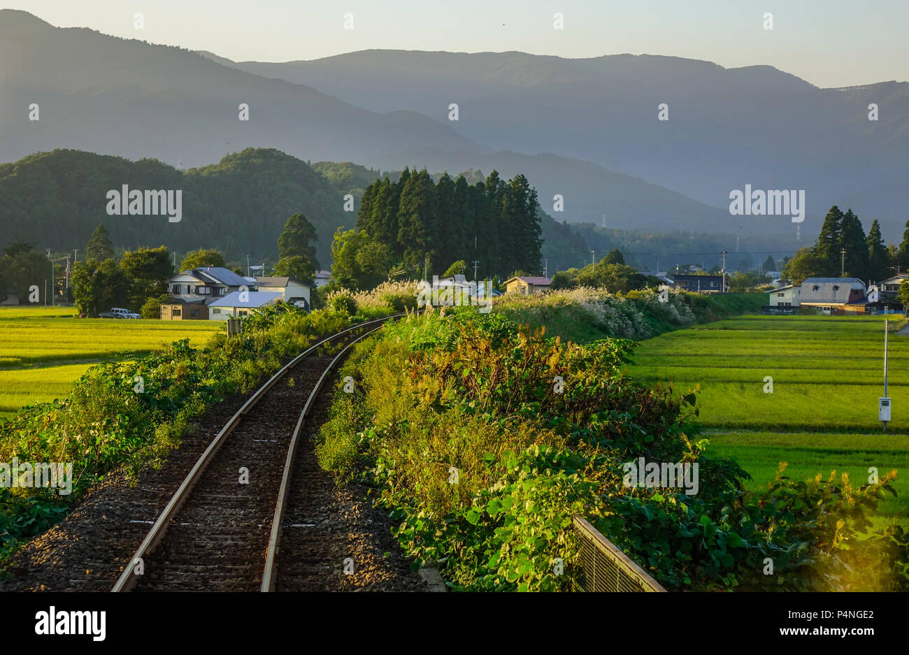 A rail track with rural scenery at summer day in Hokkaido, Japan Stock ...
