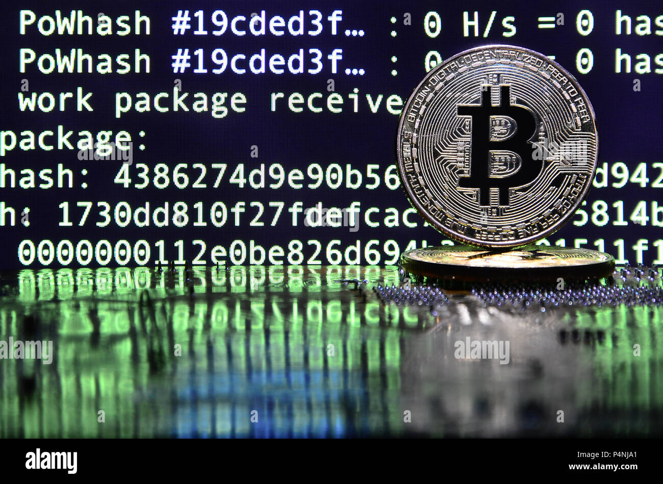 Two bitcoins lies on a videocard surface with background of screen display  of cryptocurrency mining by using the GPUs Stock Photo - Alamy