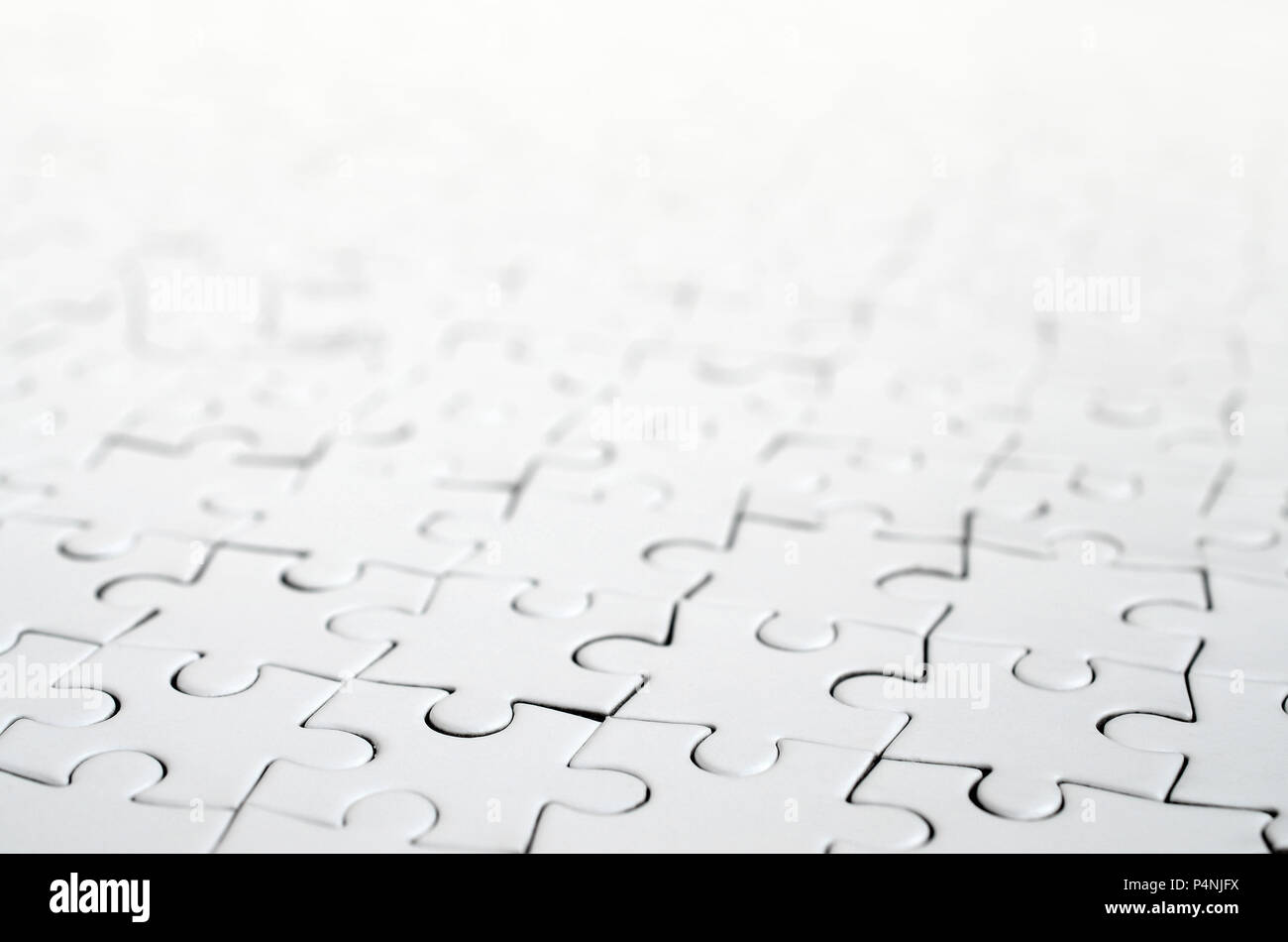 Close up of a white jigsaw puzzle in assembled state in perspective