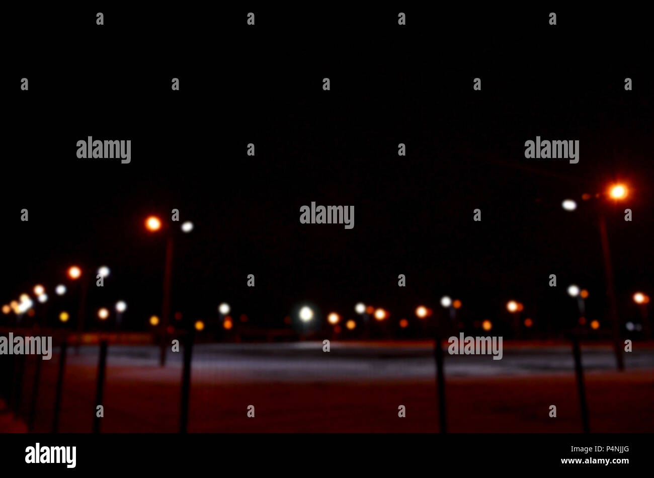 Blurred photo of school playground at night with bright lights Stock