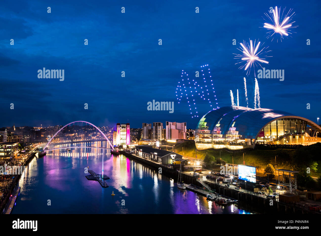 Drones fly in formation to make a letter N with fireworks (right) above the River Tyne as an expected 20,000 people attend the launch of the Great Exhibition of the North in Newcastle. Stock Photo