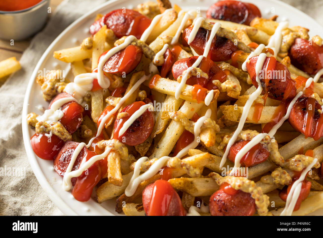 Homemade Peruvian Salchipapa Fries with Mayo Ketchup and Mustard Stock