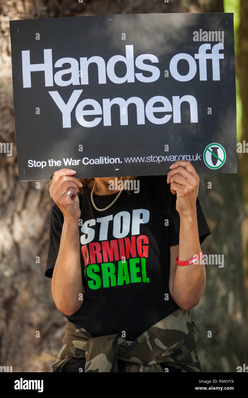 London, UK. 22nd June, 2018. A woman holds a placard reading 'Hands Off Yemen' during a protest by supporters of Stop The War Coalition and other campaign groups outside Downing Street against British arms sales to Saudi Arabia following the launch of an assault in Yemen by Saudi-backed Government forces on the port city of Hodeidah, a key entry point for humanitarian aid. Credit: Mark Kerrison/Alamy Live News Stock Photo