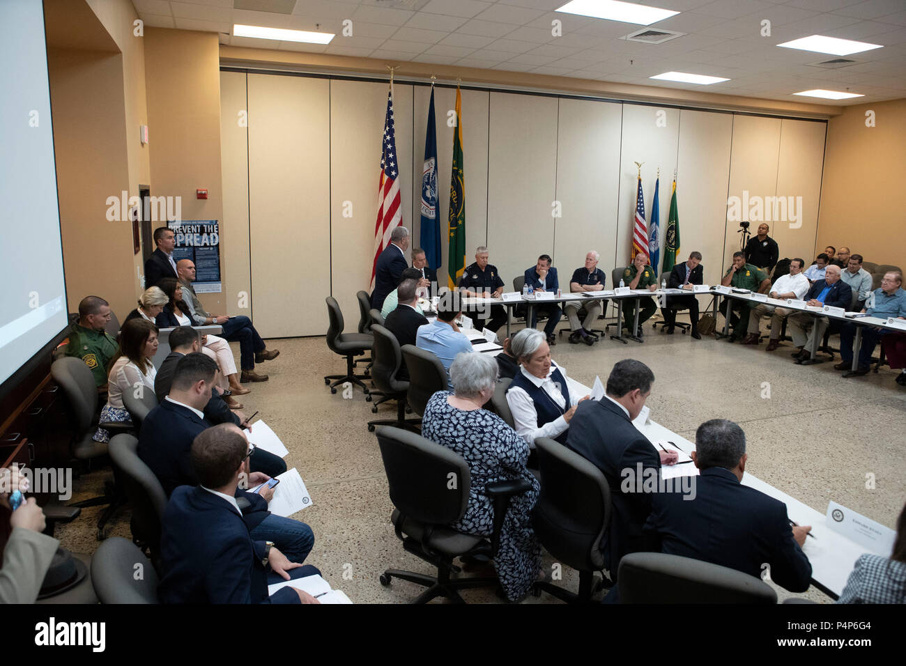Seated between flags, U.S. Senators Ted Cruz, left, and John Cornyn listen as federal and Texas officials and stakeholders meet in a round-table discussion of the immigration crisis hitting the Texas-Mexico border. Confusion and public outrage reigned regarding the Trump administration's policy of separating undocumented immigrant parents from their children after crossing into the U.S. from Mexico. Stock Photo