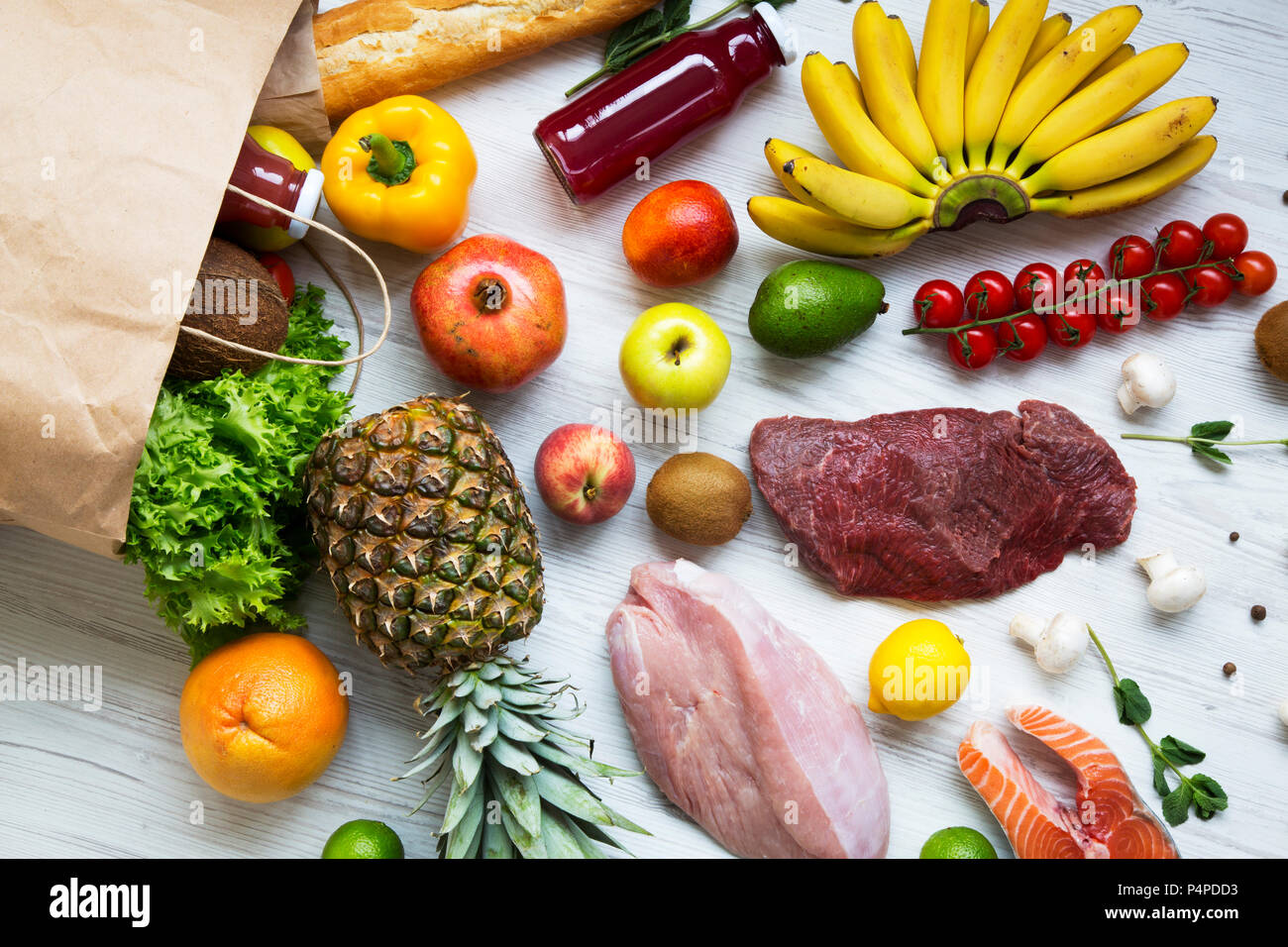 Paper bag of groceries on white wooden background, top view. Health ...