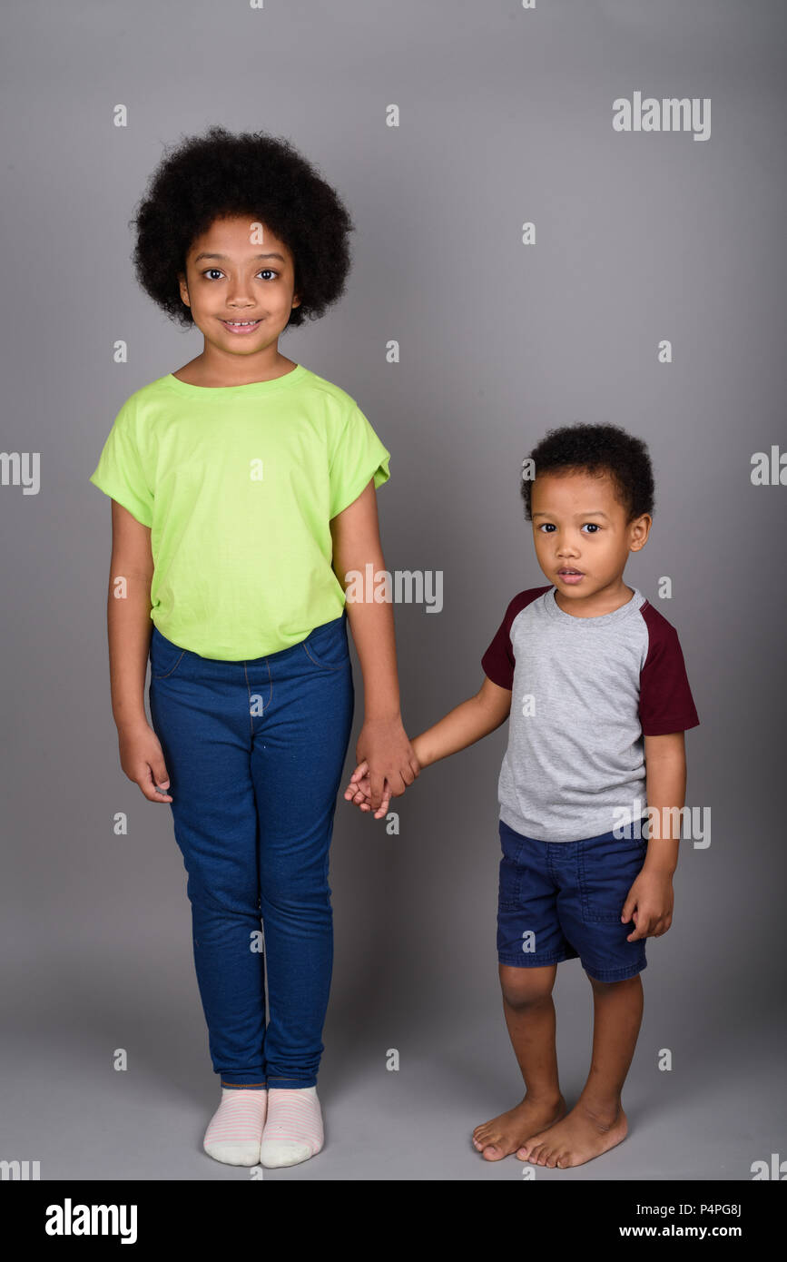 Young cute African brother and sister holding hands Stock Photo