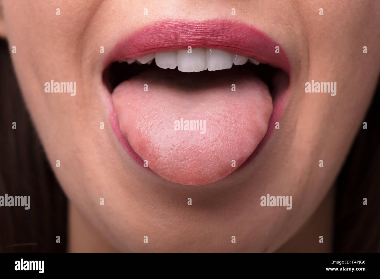 Close-up Photo Of A Woman Showing Tongue Stock Photo