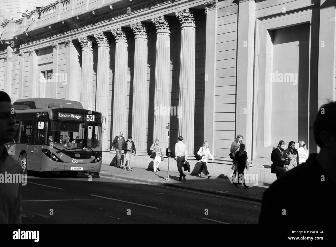 Commuters and office workers scurrying to work past the entrance of The Bank of England in the financial district of London, England, UK, PETER GRANT Stock Photo