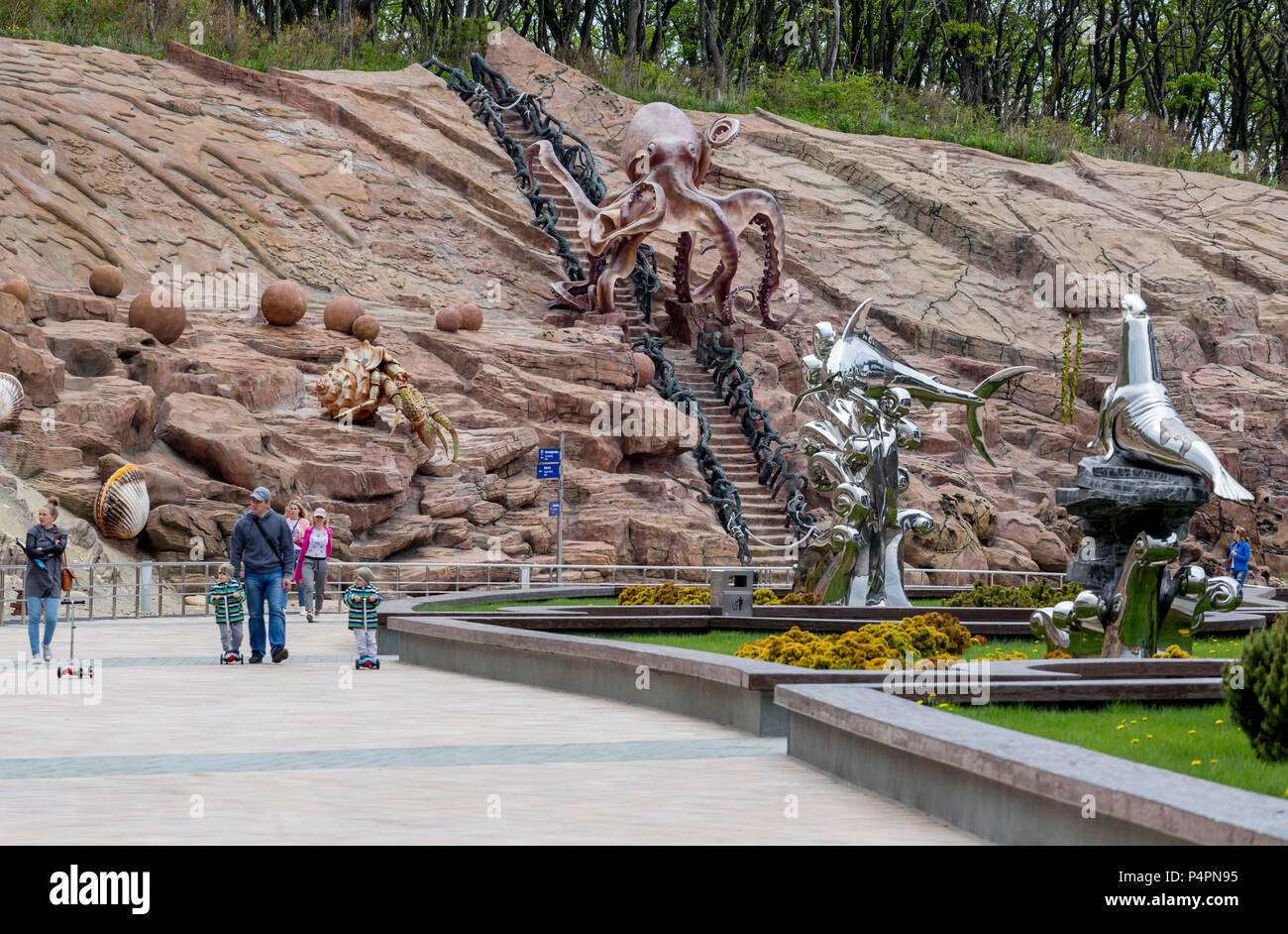 Russia, Vladivostok, 05/26/2018. View on marine amusement park of Oceanarium on Russky Island. People walking and rest in park. Many stylish sculpture Stock Photo