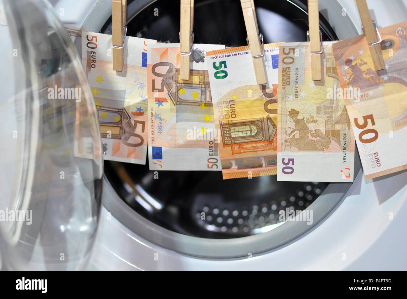 Money put to dry with hooks in front of the washing machine. Money