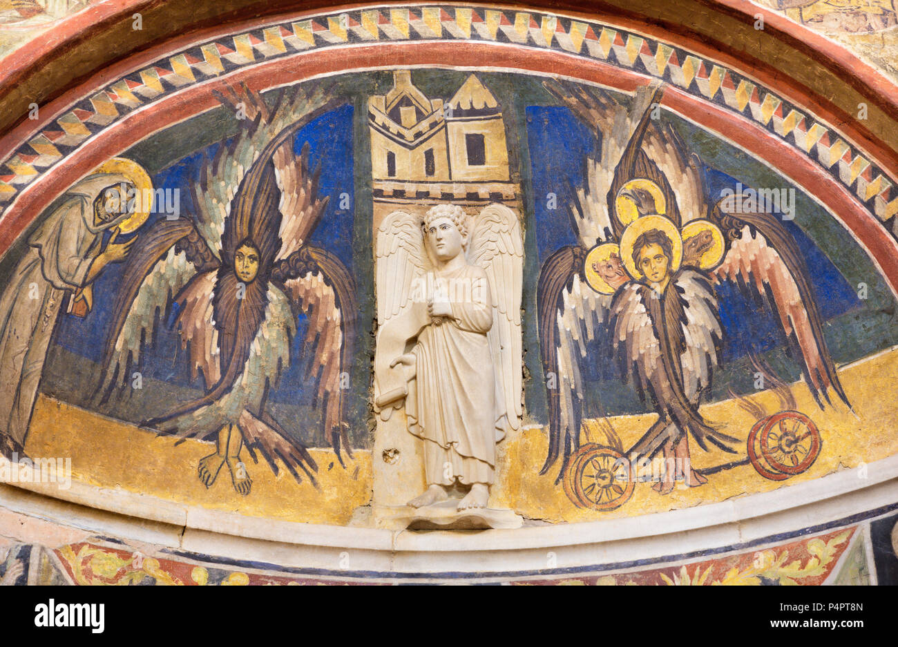 PARMA, ITALY - APRIL 16, 2018: The relief of angel and fresco of cherubs with the st. Francis of Assisi in Baptistery from 14 - 15. cent. Stock Photo