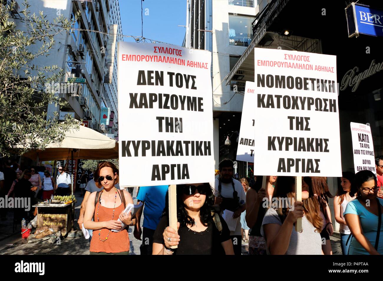 Women seen holding posters during the rally. Greek workers took to the streets of Athens to say no to opening shops on Sundays. Stock Photo
