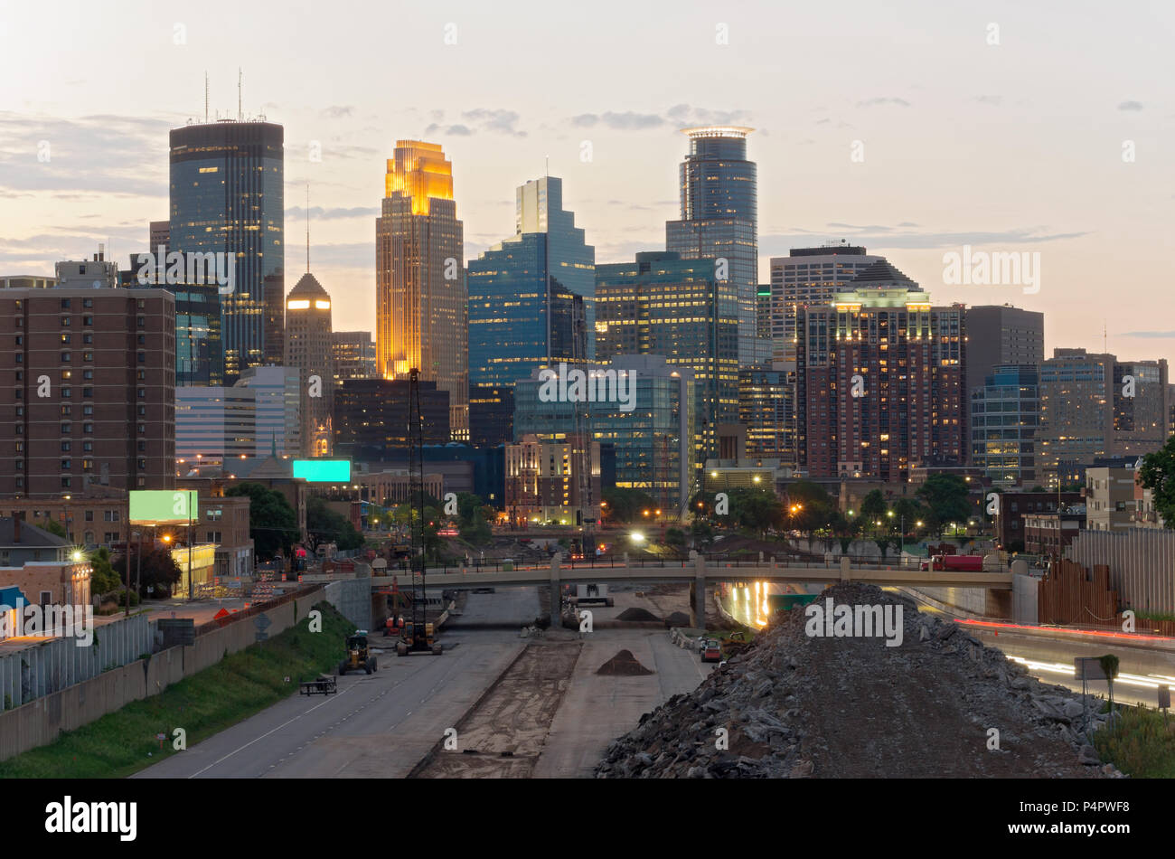 minneapolis skyline from 24th street pedestrian bridge overlooking 35w interstate into downtown showing reconstruction of interstate and office towers Stock Photo