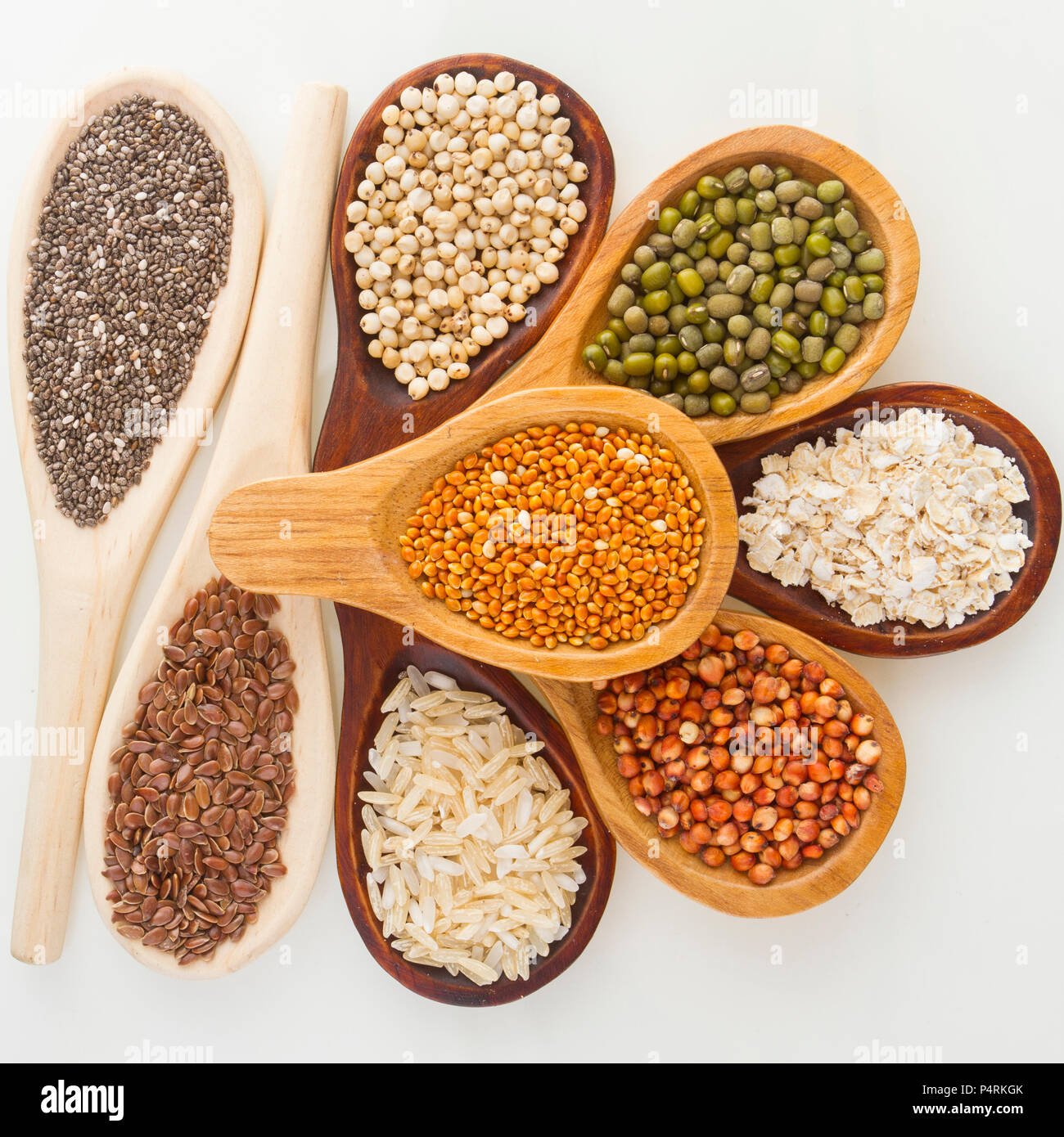 wooden spoons with assorted grains of super foods, gluten free Stock
