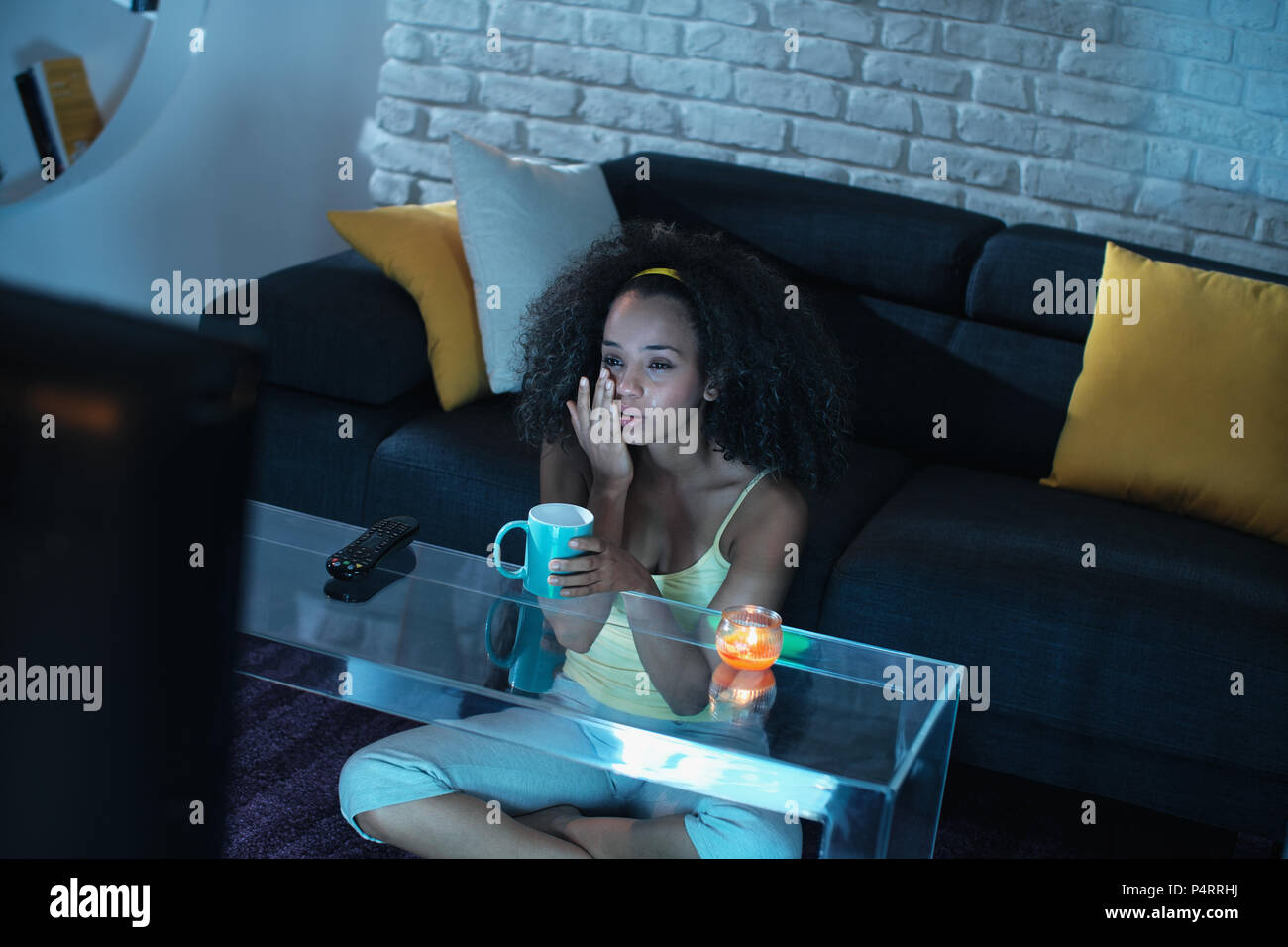 Sad Black Woman Watching Drama TV Show And Crying Stock Photo