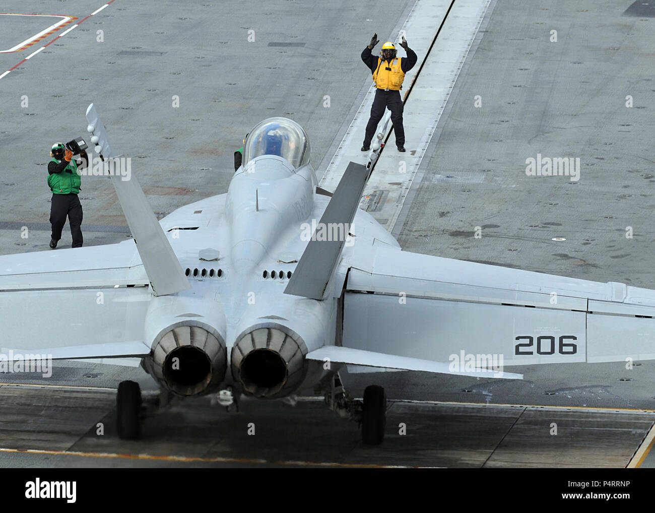 Flight deck personnel direct an F/A-18F Super Hornet from Strike Fighter Squadron (VFA) 213 aboard the aircraft carrier USS George H.W. Bush (CVN 77) Feb. 3, 2010, in the Atlantic Ocean. The ship is under way in the Atlantic Ocean conducting flight deck certification. Stock Photo
