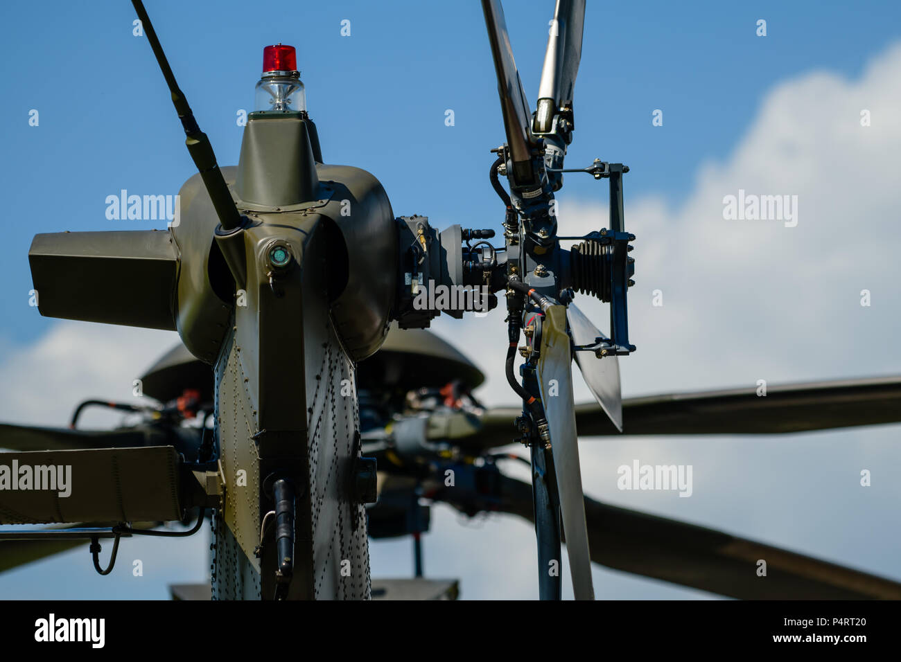 Detail of tail rotor of military helicopter, main rotor in background Stock Photo